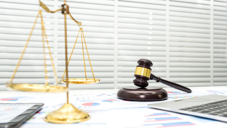 Divorced individual reviewing financial documents with attorney to prevent investment fraud and exploitation